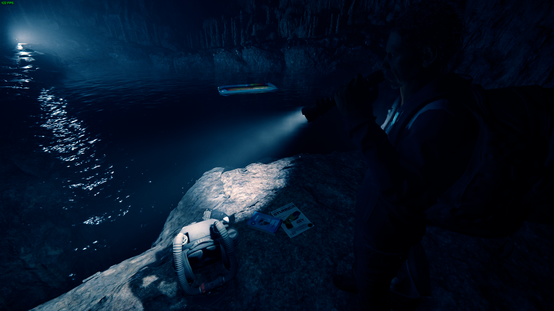 The Rebreather rests on a rock near a chamber's water edge.