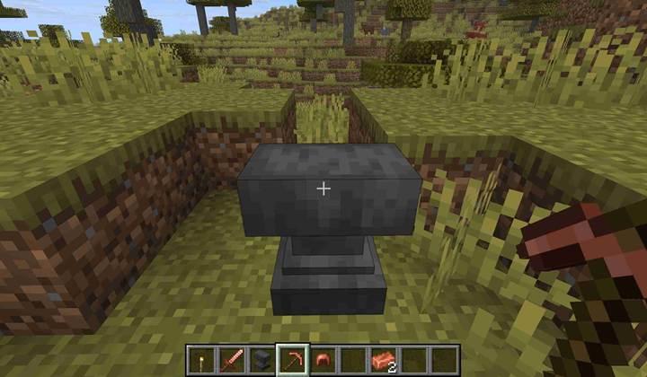 A player combines two worn copper helmets at an anvil in Minecraft to restore durability using a single copper ingot.