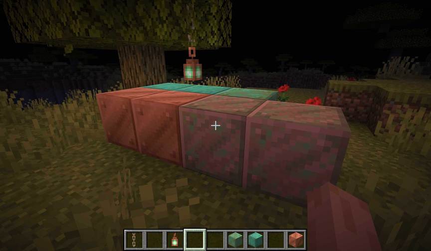 A Minecraft player places spaced copper blocks across a meadow to accelerate oxidation through even environmental exposure.