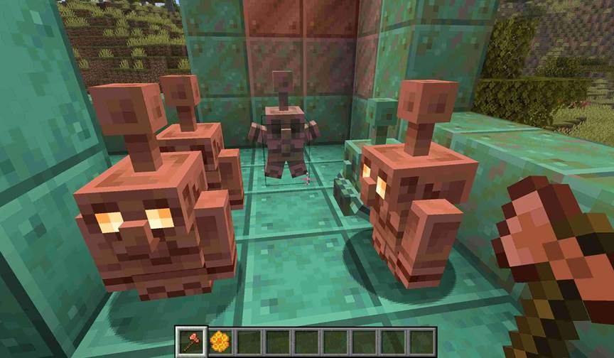 A player in Minecraft scrapes oxidation from a copper golem statue with an axe, the statue glowing briefly before reanimating into a moving golem.